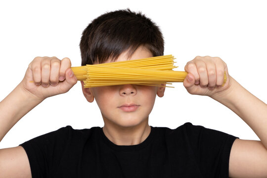 Photo of adorable young happy boy looking at camera.Isolated on the white background. Kid doing creative activity with pasta