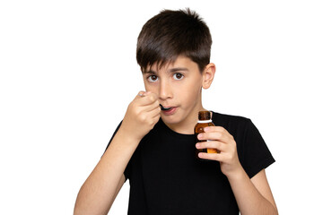 Patient boy takes medicine syrup .Isolated on the white background