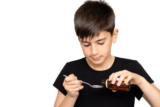 Patient boy takes medicine syrup .Isolated on the white background