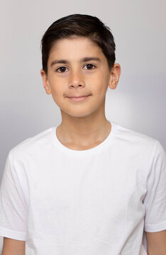 Photo of adorable young happy boy looking at camera.Isolated on the white background