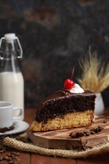 individual cake slice with coffee and milk with spike and dark background