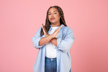 African American Obese Woman Crossing Hands In Disapproval, Pink Background