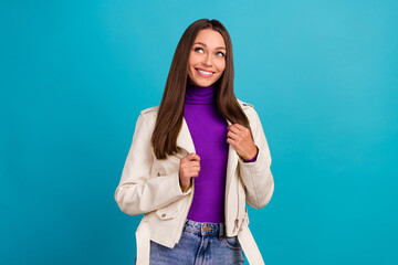 Photo of pretty pleased woman dressed white outwear eyes look up ad empty space see discount new shops isolated on blue color background