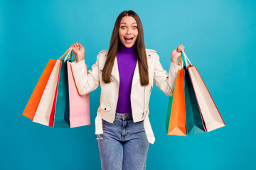 Photo of impressed overjoyed girl hands arms hold packages unexpected unbelievable sale reaction isolated on blue color background