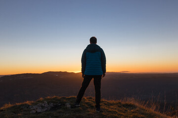 silhouette of a man standing on a hill