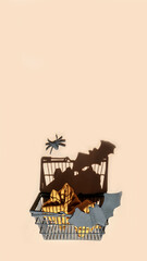Naklejka premium Halloween shopping.Festive Halloween card,background.Black basket with spiders and black pumpkins on a beige background.stories templates, copy space, smartphone format