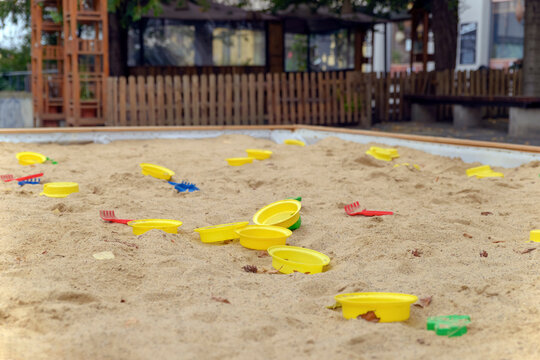 Playground Sandbox With Scattered Colorful Toys In The City