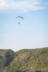 Fototapeta na wymiar Pilot powered paragliding flying in Asturies