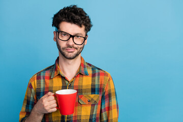 Photo of overworked tired exhausted man in tilted eyeglasses wear plaid shirt holding red cup of...