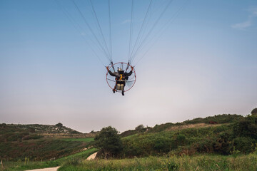 Pilot powered paragliding flying in Asturies