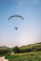 Pilot powered paragliding flying in Asturies