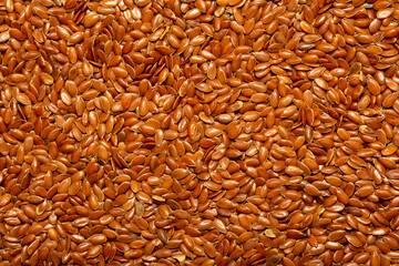 Flax seeds close-up as a background. Flaxseed for replenishment of omega 3 fatty acids. Healthy...