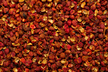 Sichuan hoju pepper. Pepper close-up as a background. Spices of China, Tibet, Japanese pepper Huajiao. Seasoning for dishes. Additive for the preparation of delicious delicacies. Sauces set.