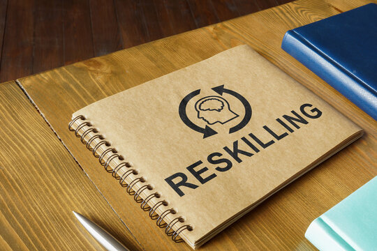 Notepad with Reskilling word and books around.