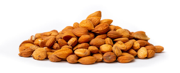 Apricot kernels peeled close-up as a background. Apricot grains heap isolated on white background.
