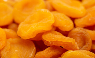 Dried apricots close up as a background. Heap of dried apricots on a white background.