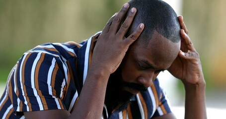 Pensive preoccupied black African person seeking solution