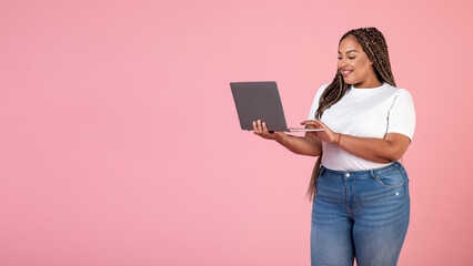 Happy Black Obese Woman Using Laptop Websurfing On Pink Background