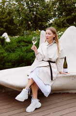 young woman drinking wine in the park