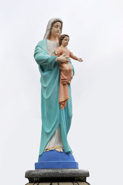 Statue of the Virgin Mary with little Jesus on the hands isolated on white background
