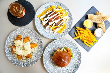 Delicious meat kebab with fresh vegetable salad served with variety of Turkish dishes and appetizers. Top view of assorted Turkish food and meze, tasty and healthy Mediterranean cuisine.