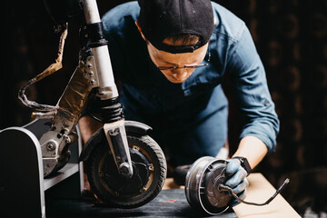 repair and maintenance of an electric scooter, replacement of the electric motor of a custom electric scooter. - obrazy, fototapety, plakaty