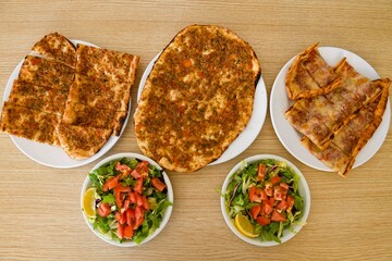 Delicious meat kebab with fresh vegetable salad served with variety of Turkish dishes and appetizers. Top view of assorted Turkish food and meze, tasty and healthy Mediterranean cuisine.