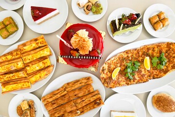 Delicious meat kebab with fresh vegetable salad served with variety of Turkish dishes and appetizers. Top view of assorted Turkish food and meze, tasty and healthy Mediterranean cuisine.