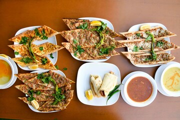 Delicious meat kebab with fresh vegetable salad served with variety of Turkish dishes and appetizers. Top view of assorted Turkish food and meze, tasty and healthy Mediterranean cuisine.