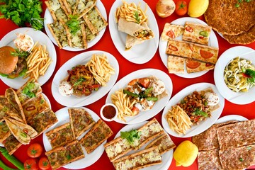 Delicious meat kebab with fresh vegetable salad served with variety of Turkish dishes and appetizers. Top view of assorted Turkish food and meze, tasty and healthy Mediterranean cuisine.