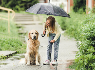 Girl with golden retriever dog in rainy day © tan4ikk