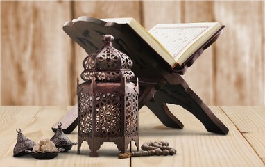 The Holy Al Quran with written Arabic calligraphy and rosary beads or tasbih