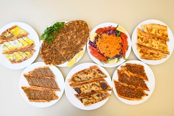 Delicious meat kebab with fresh vegetable salad served with variety of Turkish dishes and appetizers. Top view of assorted Turkish food and meze, tasty and healthy Mediterranean cuisine.