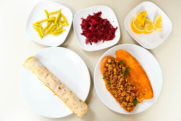 Delicious meat kebab with fresh vegetable salad served with variety of Turkish dishes and appetizers. Top view of assorted Turkish food and meze, tasty and healthy Mediterranean cuisine.