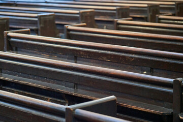 Abstract view of rows of wooden church pews