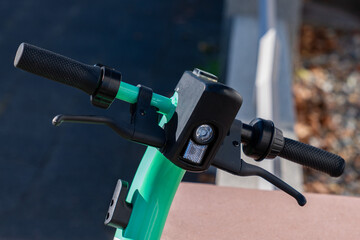 Close up of handlebar of electric scooter with throttle lever for stop and go.