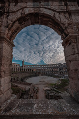 Fototapeta na wymiar Beautiful roman colloseum or amphiteatre in Pula on a sunny summer evening with romantic feeling. Details parts of beautiful roman structure in golden light.