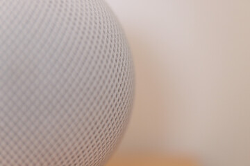 Macro close up of a white wireless speaker of hi tech audio system