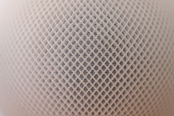 Macro close up of a white wireless speaker of hi tech audio system
