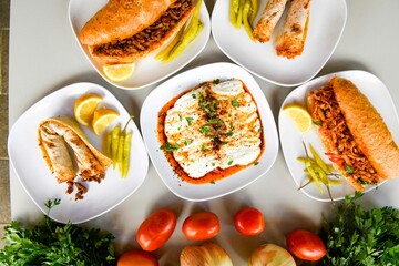 Delicious meat kebab with fresh vegetable salad served with variety of Turkish dishes and appetizers. Top view of assorted Turkish food and meze, tasty and healthy Mediterranean cuisine.