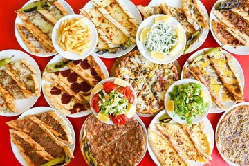 Delicious meat kebab with fresh vegetable salad served with variety of Turkish dishes and appetizers. Top view of assorted Turkish food and meze, tasty and healthy Mediterranean cuisine.