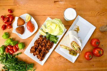 Traditional Turkish cuisine. Pizza, pita, pidesi, sucuk, hummus, kebab. Many dishes on the table. Serving dishes in restaurant. Background image. Top view, flat lay