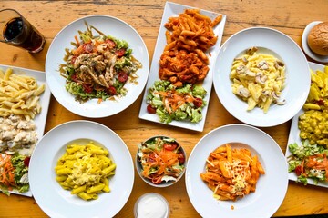 Delicious meat kebab with fresh vegetable salad served with variety of Turkish dishes and appetizers. Top view of assorted Turkish food and meze, tasty and healthy Mediterranean cuisine.