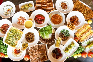 Traditional Turkish cuisine. Pizza, pita, pidesi, sucuk, hummus, kebab. Many dishes on the table. Serving dishes in restaurant. Background image. Top view, flat lay