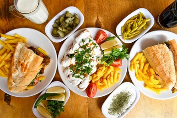 Delicious meat kebab with fresh vegetable salad served with variety of Turkish dishes and appetizers. Top view of assorted Turkish food and meze, tasty and healthy Mediterranean cuisine.