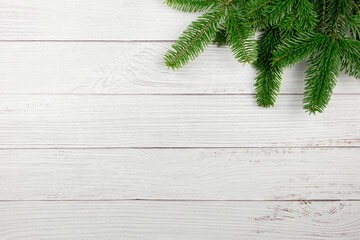 Christmas flat lay background with fir tree branches, holiday decorations on white wooden background. Top view. Copy space.