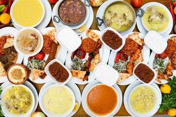 Delicious meat kebab with fresh vegetable salad served with variety of Turkish dishes and appetizers. Top view of assorted Turkish food and meze, tasty and healthy Mediterranean cuisine.