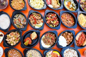 Traditional Turkish cuisine. Pizza, pita, pidesi, sucuk, hummus, kebab. Many dishes on the table. Serving dishes in restaurant. Background image. Top view, flat lay