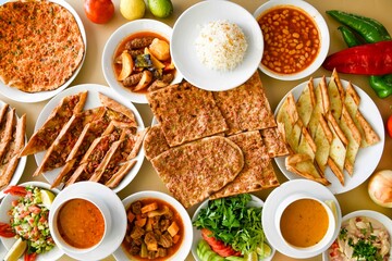 Delicious meat kebab with fresh vegetable salad served with variety of Turkish dishes and appetizers. Top view of assorted Turkish food and meze, tasty and healthy Mediterranean cuisine.