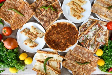 Delicious meat kebab with fresh vegetable salad served with variety of Turkish dishes and appetizers. Top view of assorted Turkish food and meze, tasty and healthy Mediterranean cuisine.